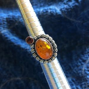 Silver ring with amber colored stone and crystal